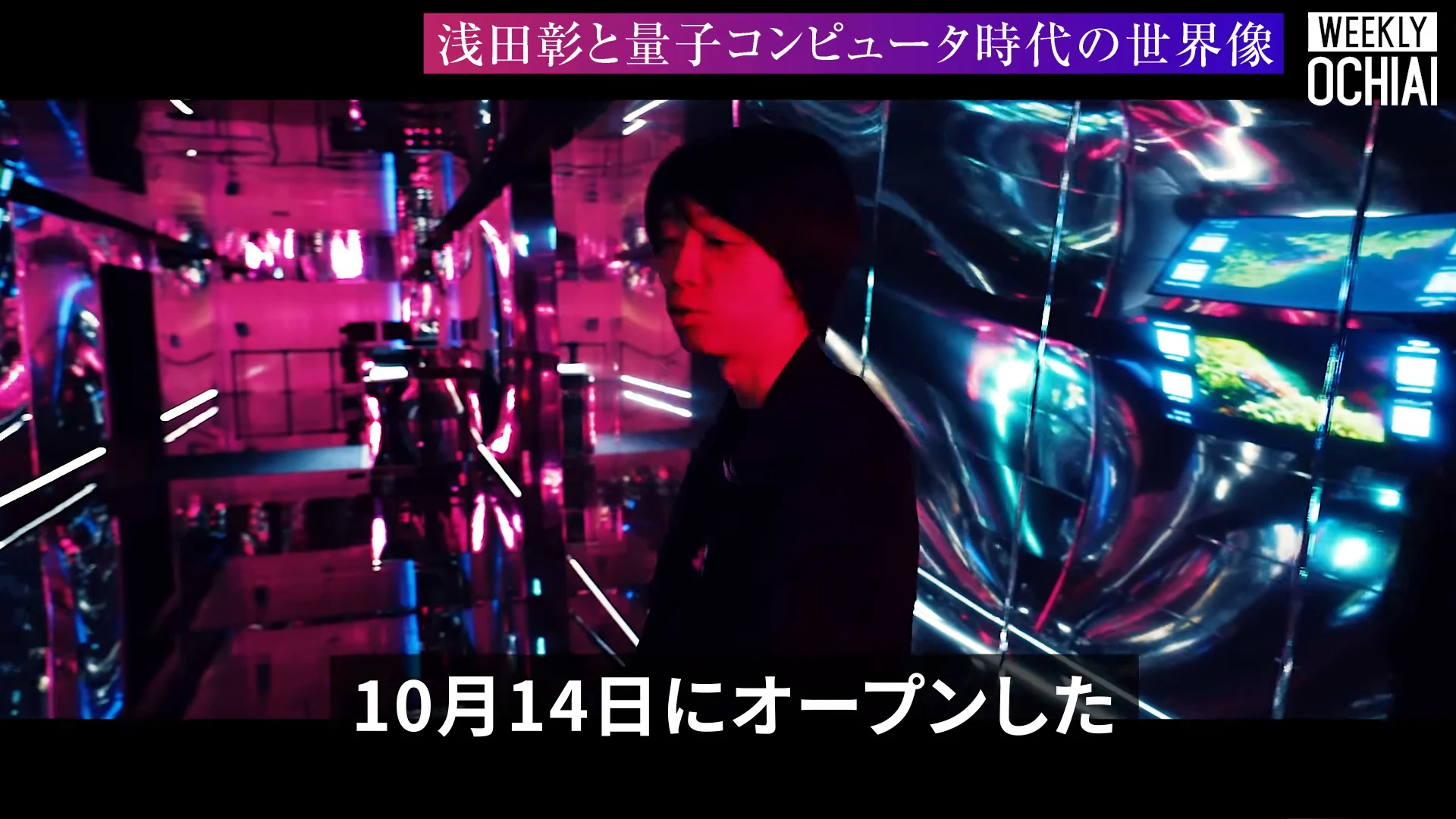 画面上に浅田彰と量子コンピュータ時代の世界像の帯、下に10月14日にオープンしたの字幕が出て、ピンクと青の鏡張りの展示空間に黒い服の人物が立つ動画の場面