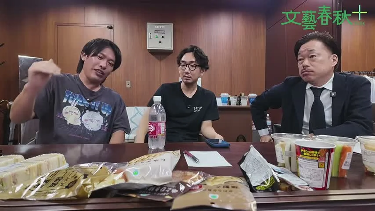 動画キャプチャ: 3人が机で話す場面（0:18:08頃）